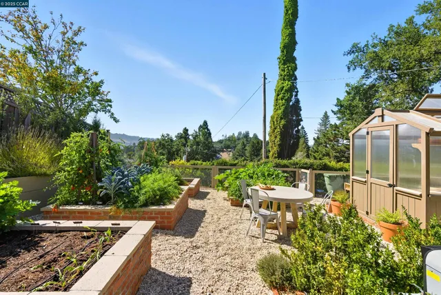 a view of a house with garden bath tub and a tree