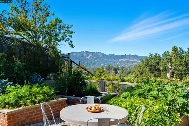 a view of a patio with couches table and chairs and potted plants