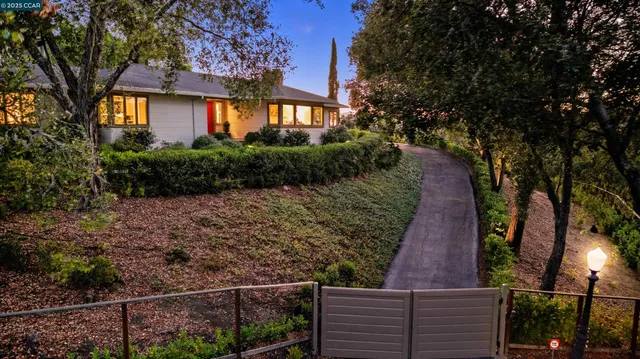 a view of street along with house and trees