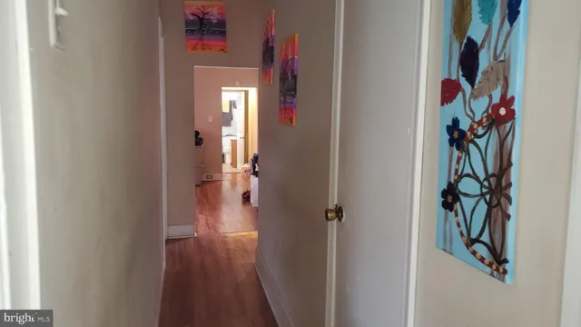 a view of a hallway with wooden shelves