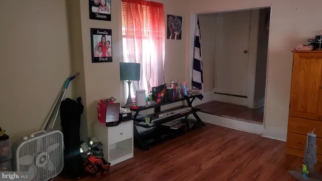 a room with wooden floor and a window