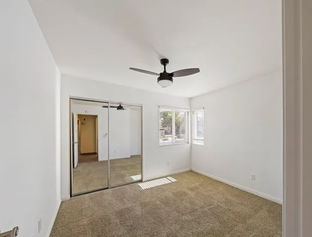 an empty room with windows and closet