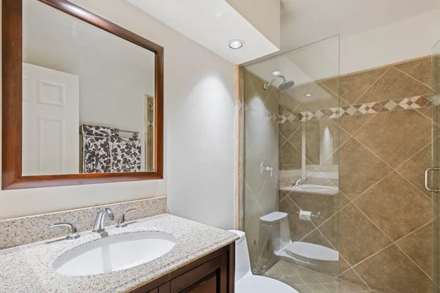 a bathroom with a sink toilet and shower