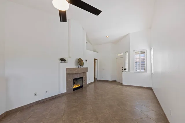 an empty room with fireplace and window