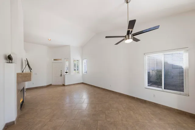 a view of a livingroom with a ceiling fan and window
