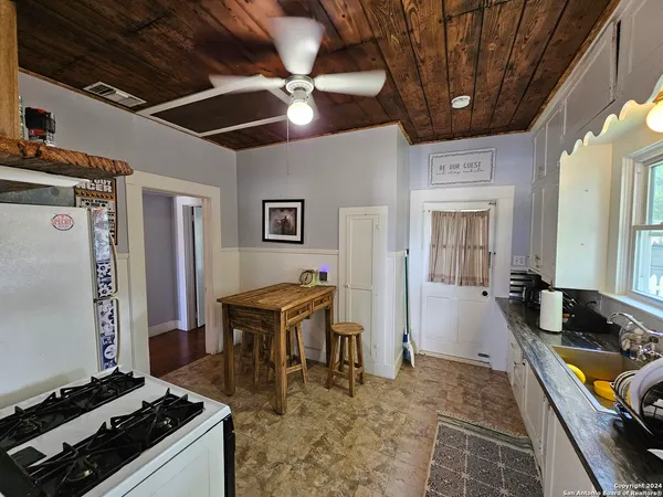 a kitchen with stove and cabinets