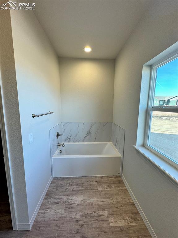 3955 Yoder Road Yoder, CO 80864 - Photo 24 of 27 Bathroom with a washtub and wood-type flooring