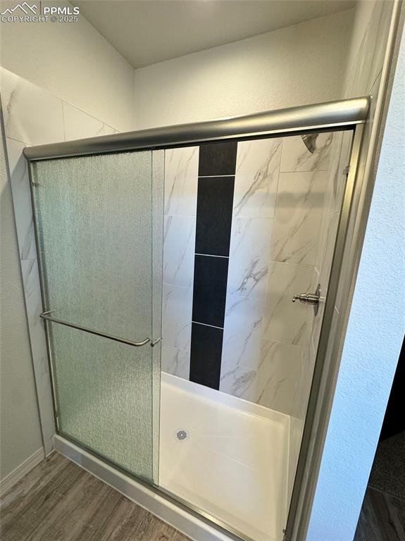 3955 Yoder Road Yoder, CO 80864 - Photo 25 of 27 Bathroom featuring a shower with door and hardwood / wood-style flooring