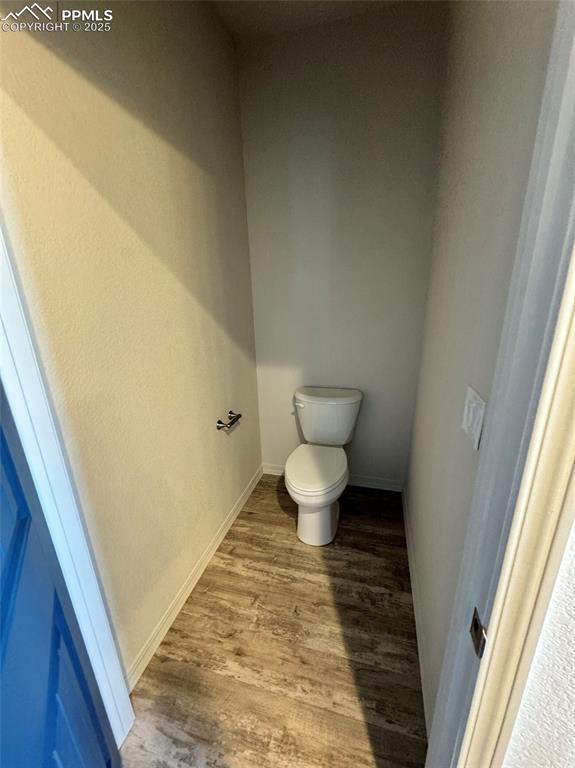 3955 Yoder Road Yoder, CO 80864 - Photo 26 of 27 Bathroom featuring toilet and wood-type flooring