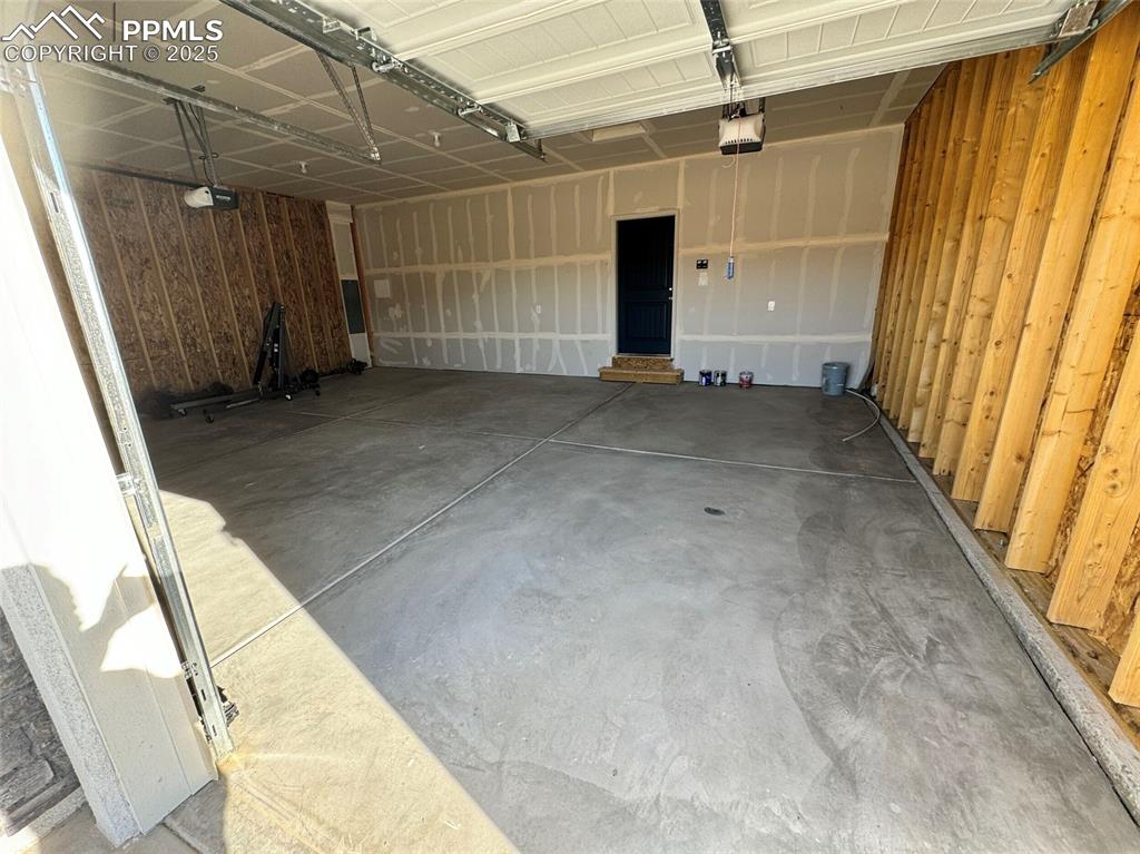 3955 Yoder Road Yoder, CO 80864 - Photo 5 of 27 Garage featuring wood walls and a garage door opener