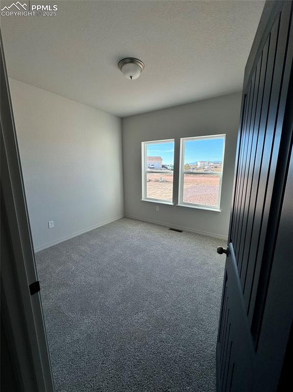 3955 Yoder Road Yoder, CO 80864 - Photo 10 of 27 Carpeted spare room with a textured ceiling