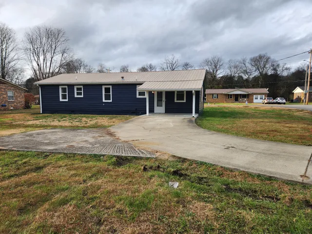 a large house with a big yard and large trees