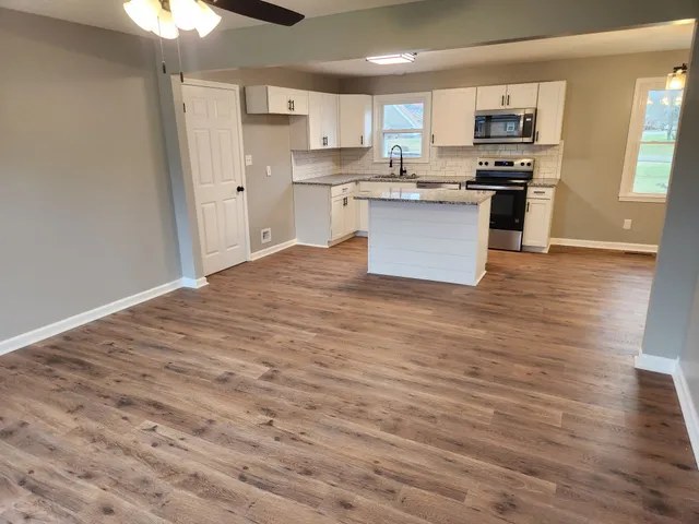 a view of kitchen with sink microwave and stove
