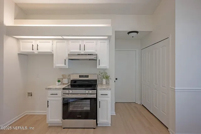 a kitchen with stainless steel appliances a stove and a refrigerator
