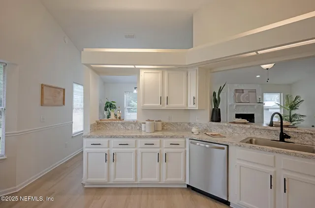 a spacious bathroom with a granite countertop sink a mirror and