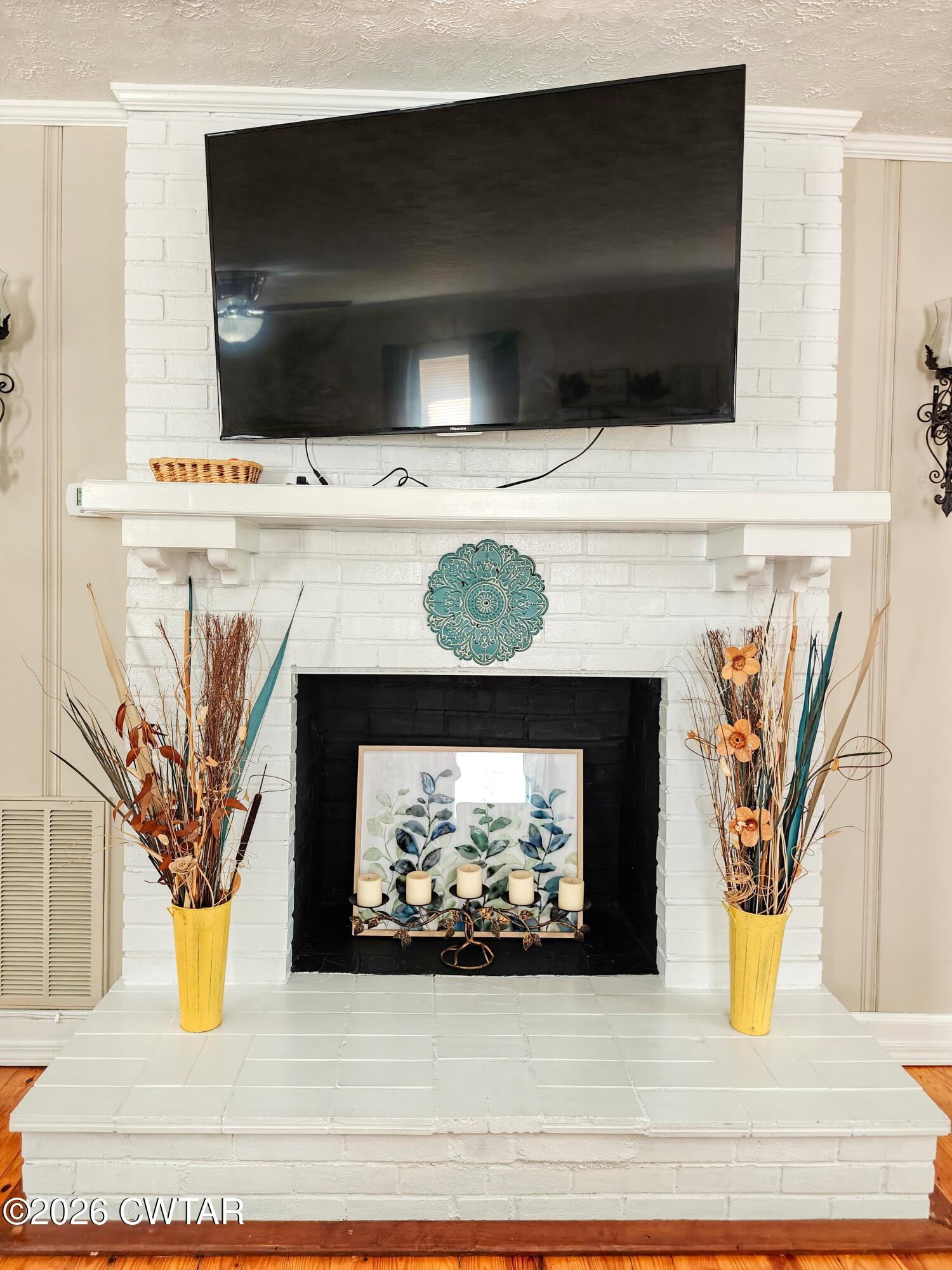 195 Coast Guard Road Buchanan, TN 38222 - Photo 11 of 34 a living room with a fireplace and a flat screen tv