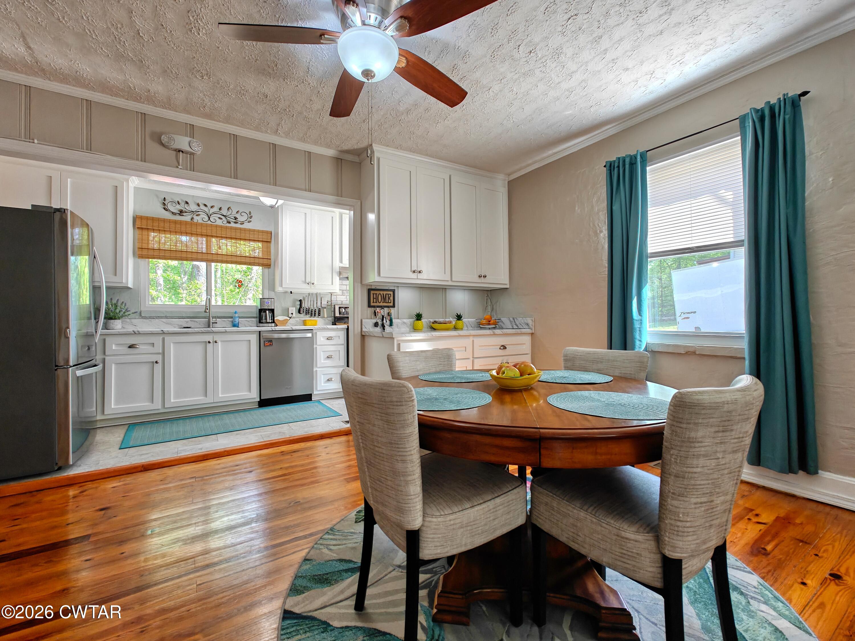 195 Coast Guard Road Buchanan, TN 38222 - Photo 14 of 34 a kitchen with granite countertop wooden floors and white appliances