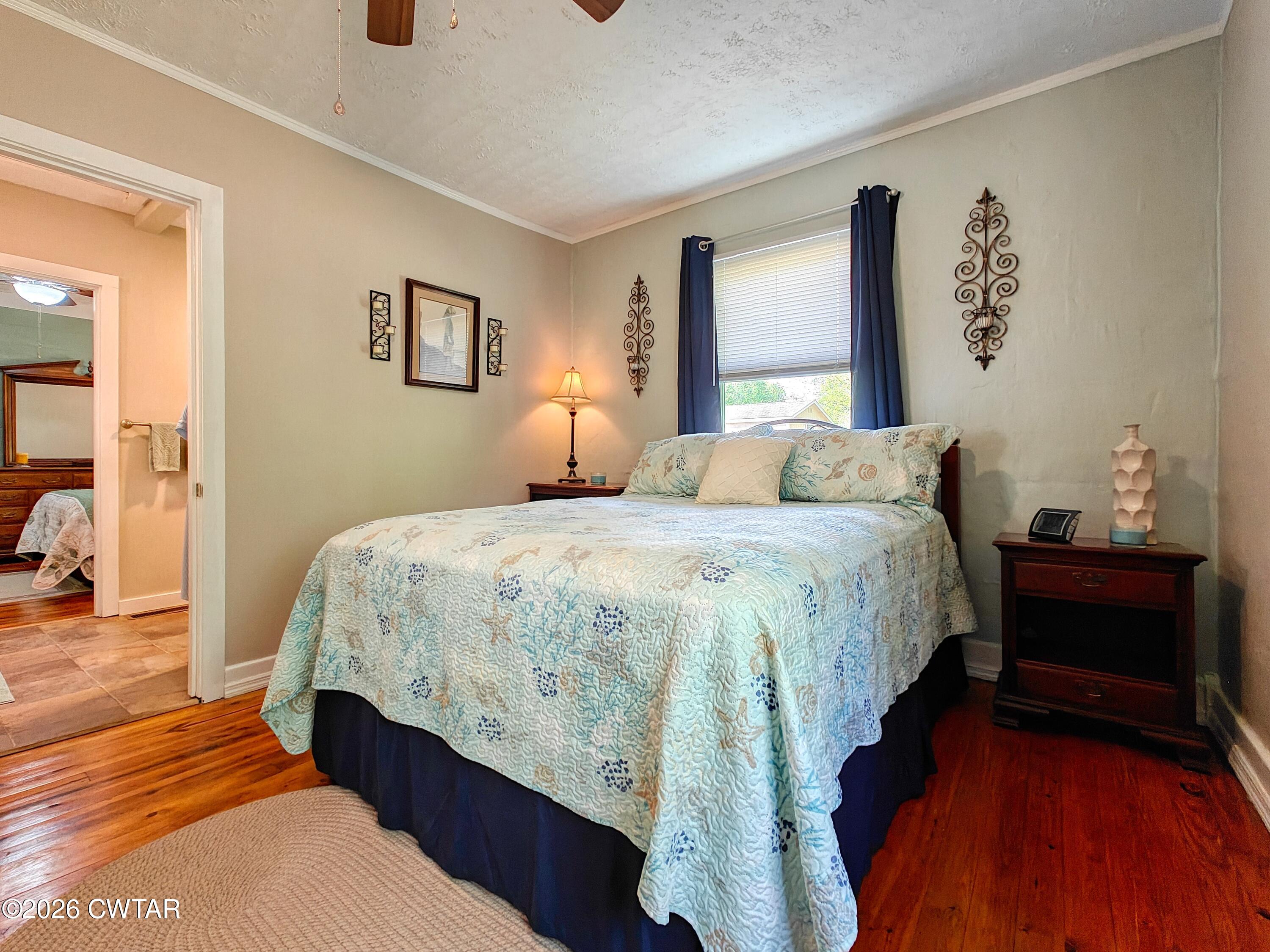 195 Coast Guard Road Buchanan, TN 38222 - Photo 18 of 34 a bedroom with a bed and wooden floor