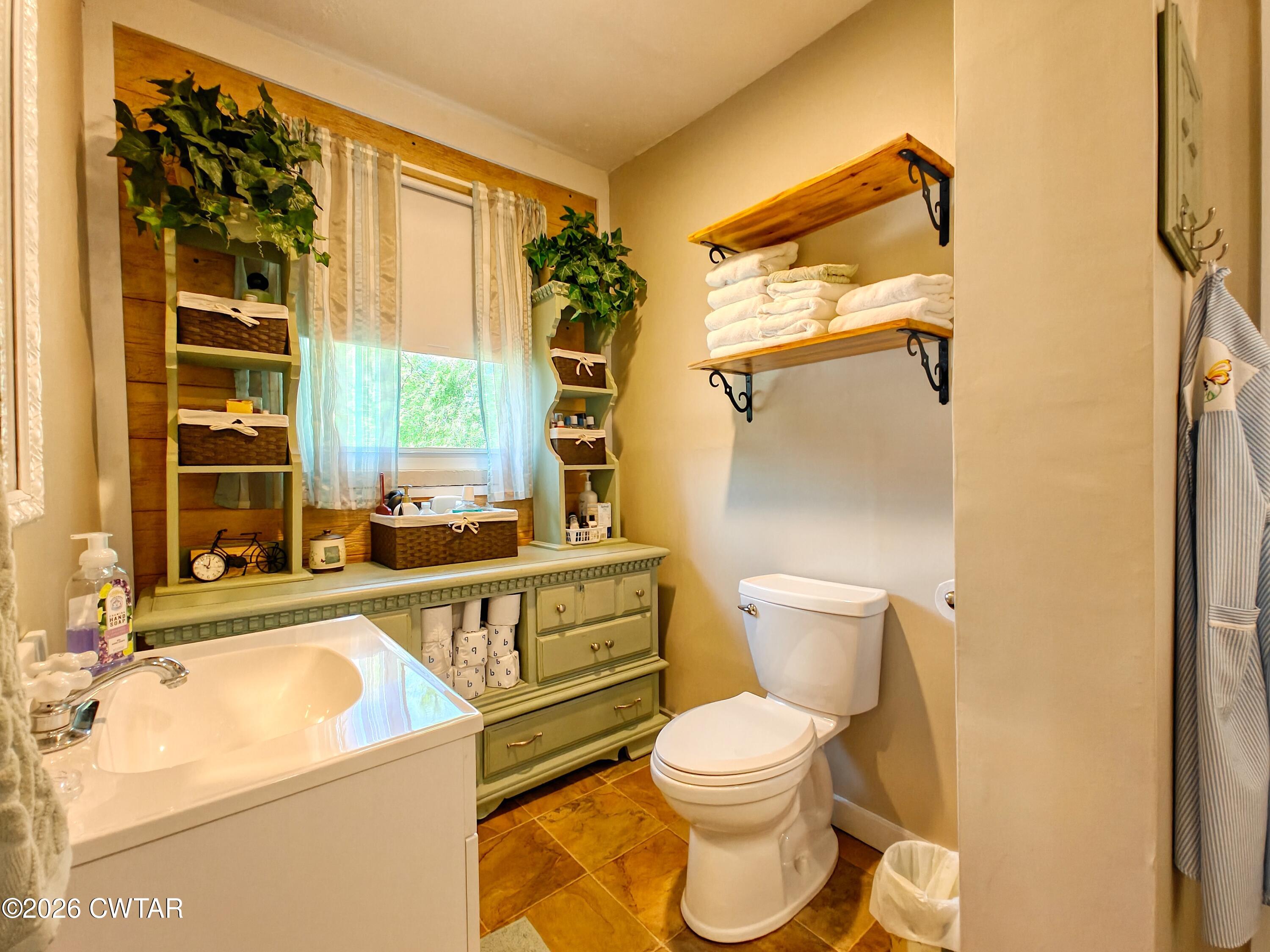 195 Coast Guard Road Buchanan, TN 38222 - Photo 20 of 34 a bathroom with a sink and a large mirror