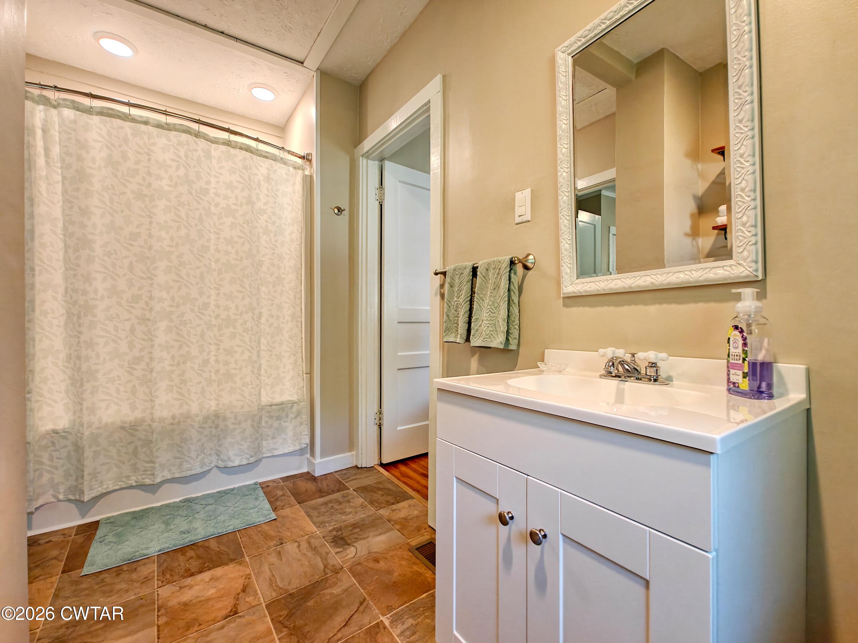 195 Coast Guard Road Buchanan, TN 38222 - Photo 21 of 34 a bathroom with a sink and a mirror