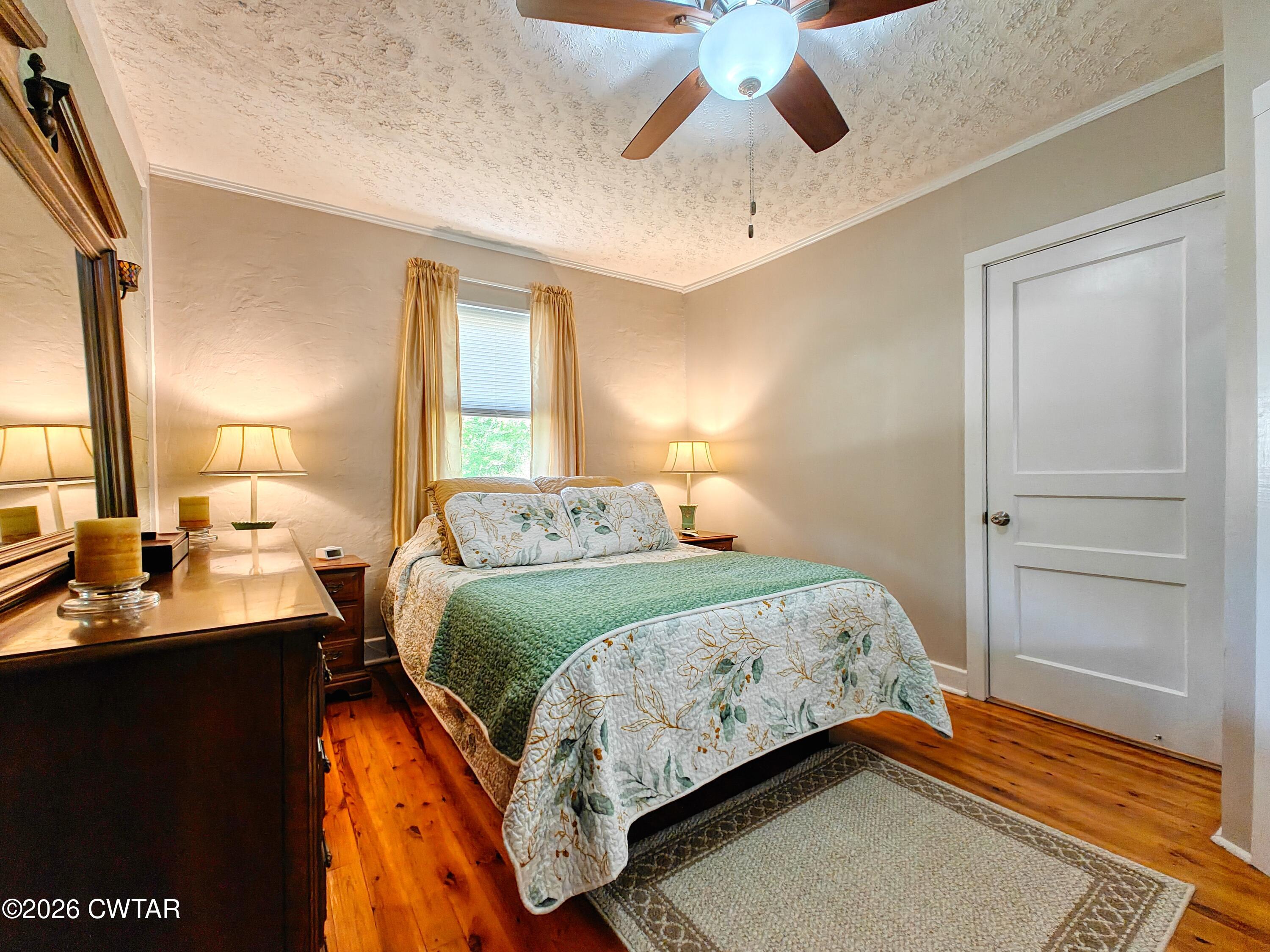 195 Coast Guard Road Buchanan, TN 38222 - Photo 22 of 34 a bedroom with a bed and a chandelier