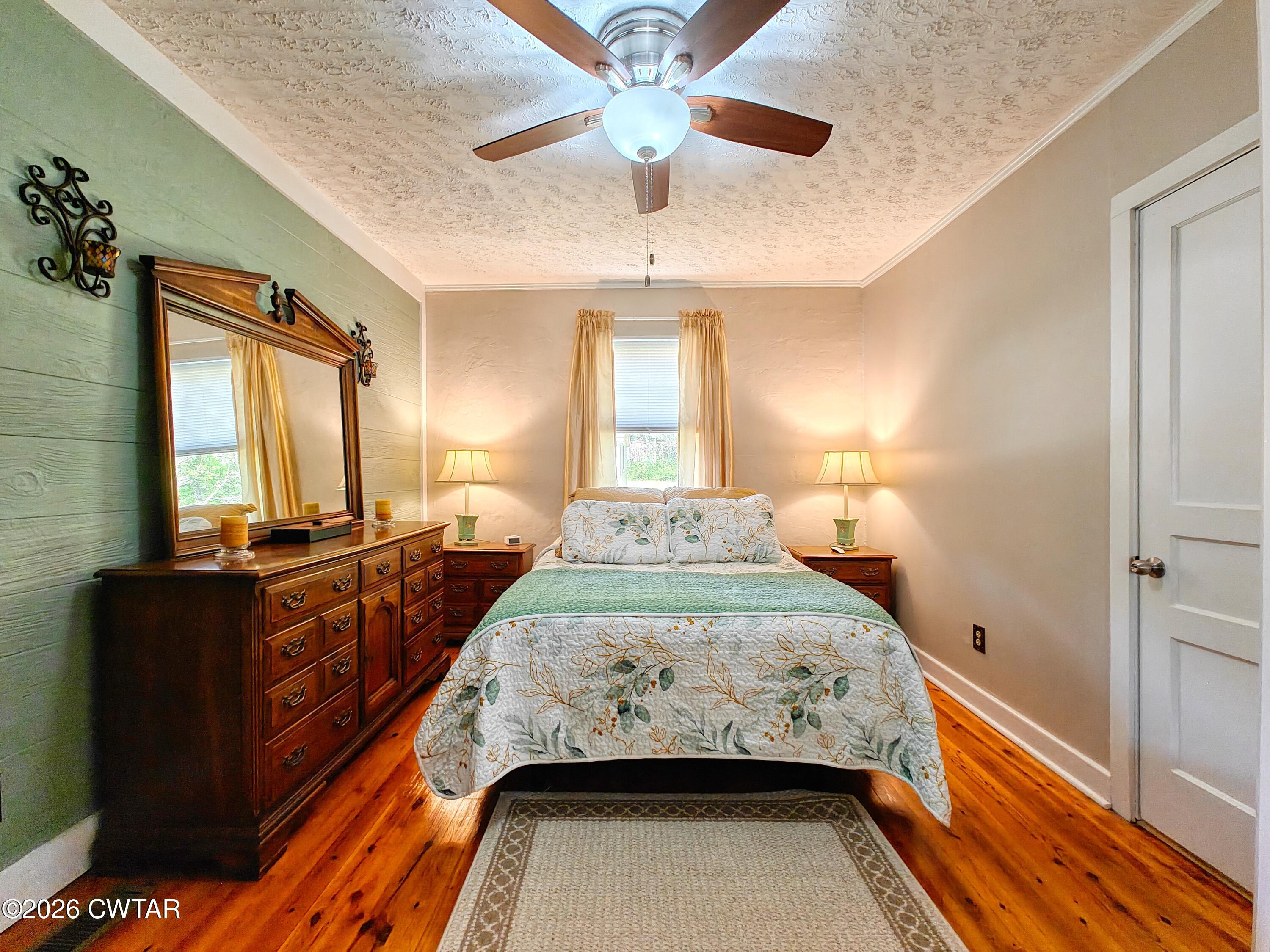 195 Coast Guard Road Buchanan, TN 38222 - Photo 23 of 34 a bedroom with a bed and a chandelier