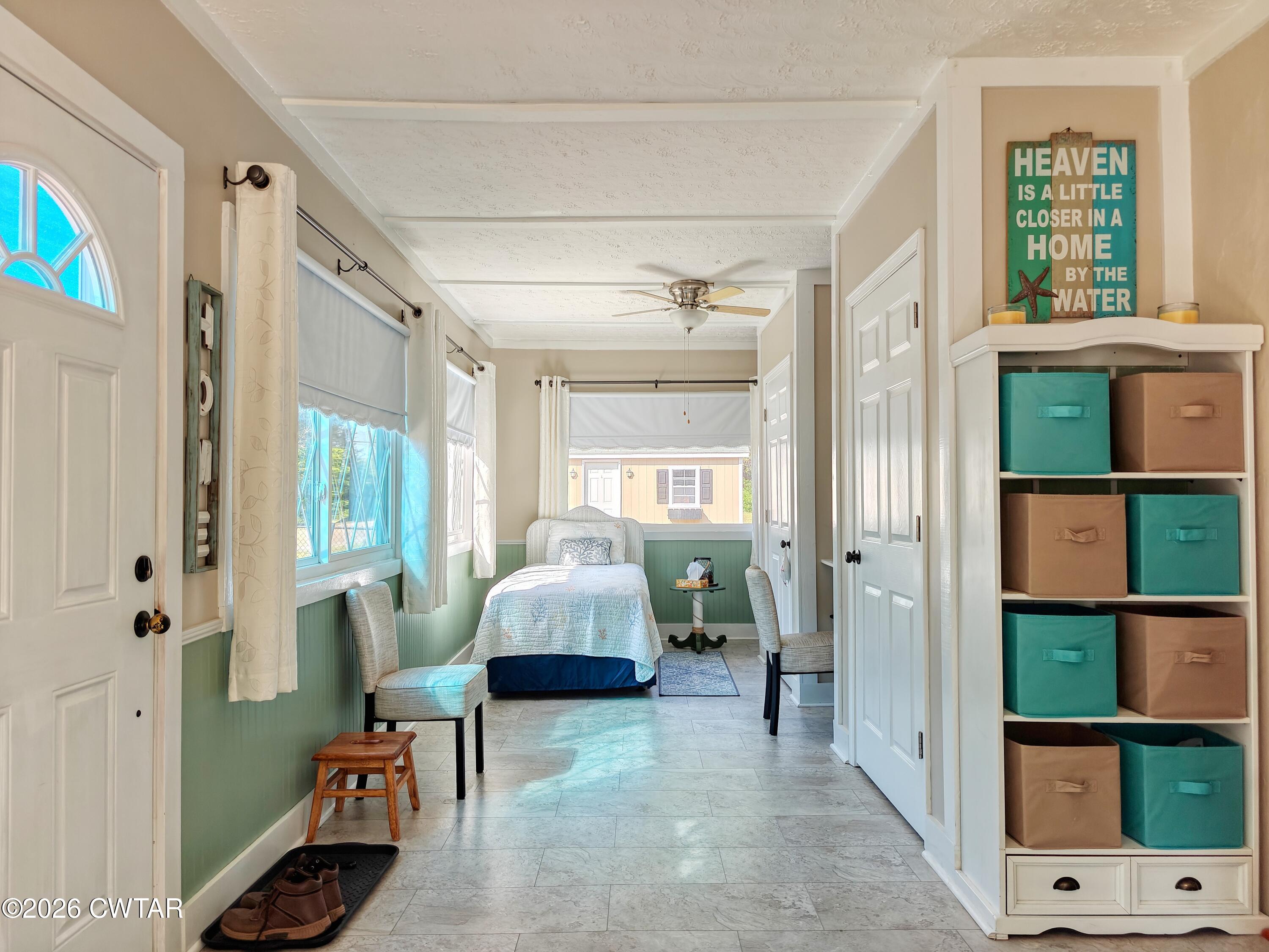 195 Coast Guard Road Buchanan, TN 38222 - Photo 24 of 34 a living room with furniture a large window and a potted plant