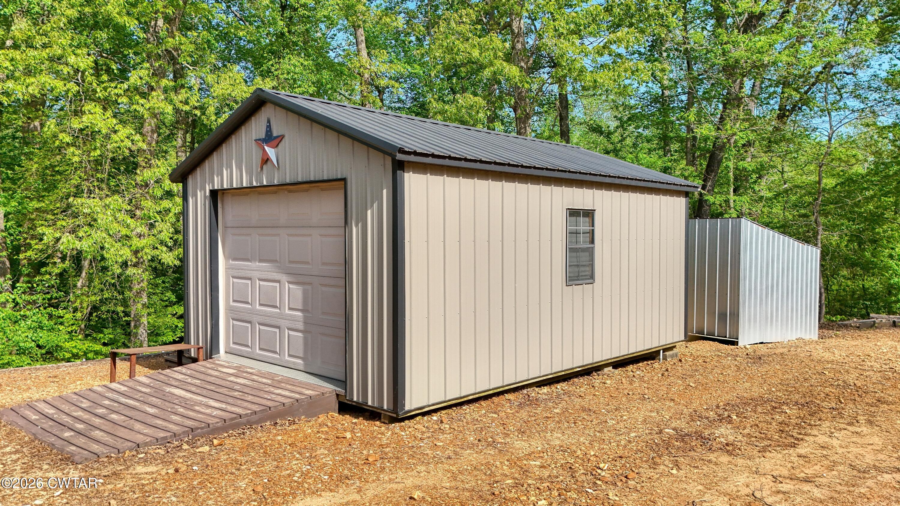 195 Coast Guard Road Buchanan, TN 38222 - Photo 30 of 34 a view of wooden house with a small yard
