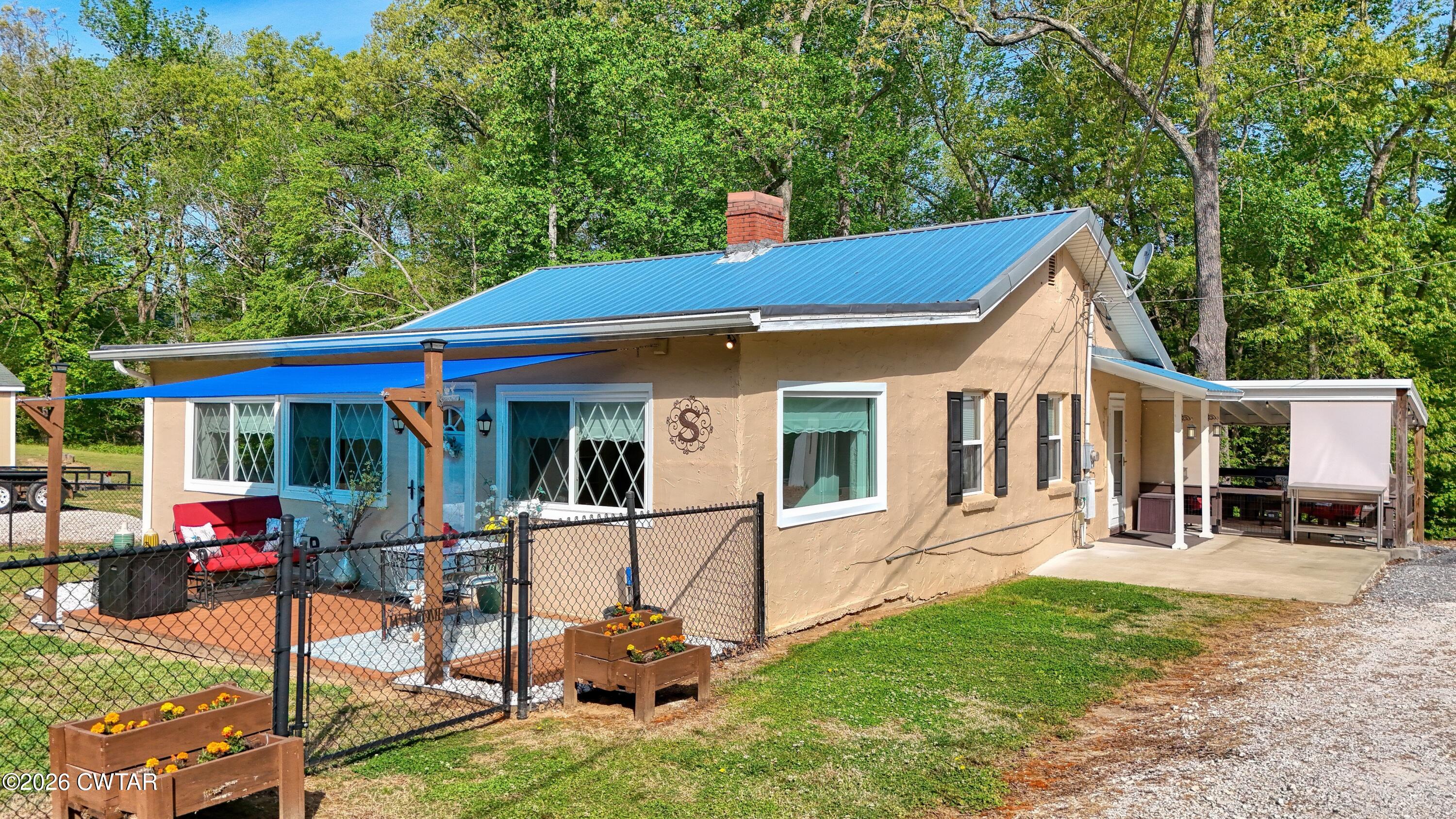 195 Coast Guard Road Buchanan, TN 38222 - Photo 3 of 34 a view of a house with wooden deck and furniture
