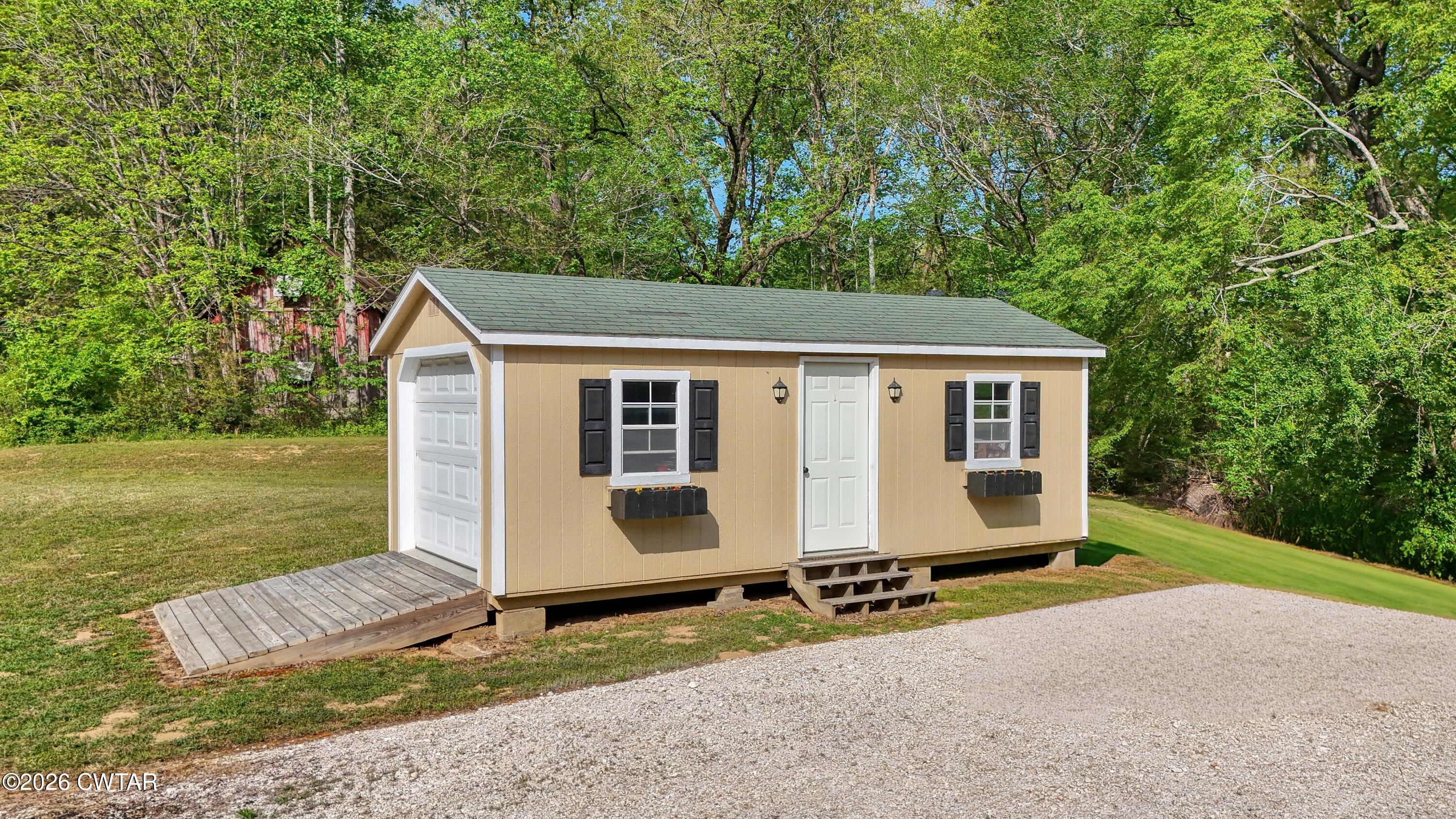 195 Coast Guard Road Buchanan, TN 38222 - Photo 31 of 34 a view of a house with backyard