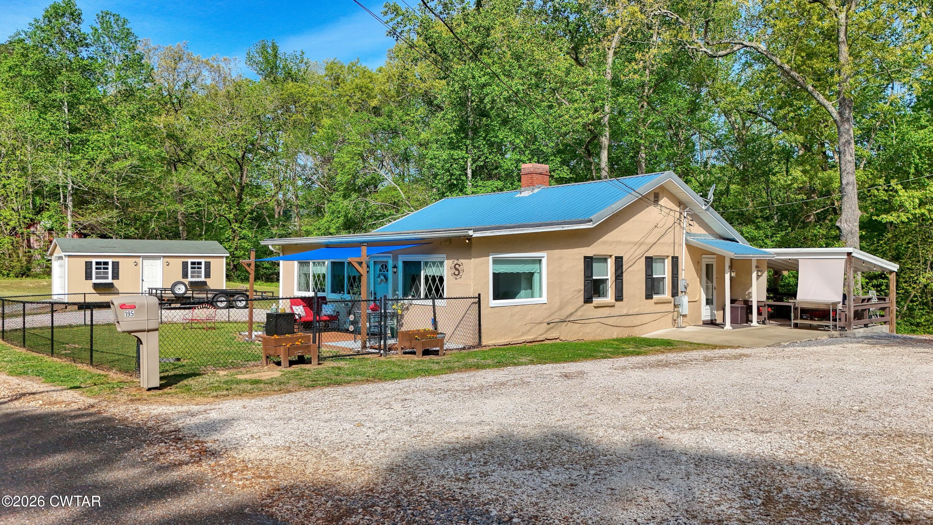 195 Coast Guard Road Buchanan, TN 38222 - Photo 4 of 34 a front view of a house with garden
