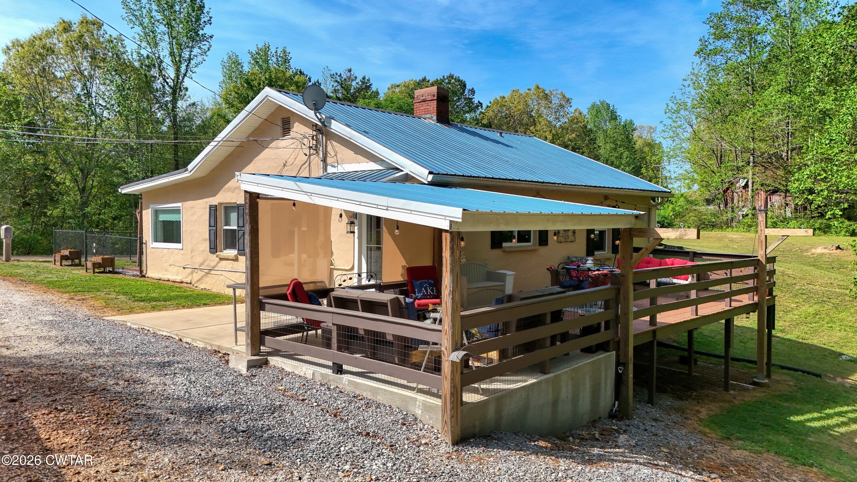 195 Coast Guard Road Buchanan, TN 38222 - Photo 7 of 34 a view of a chairs and table in backyard of the house
