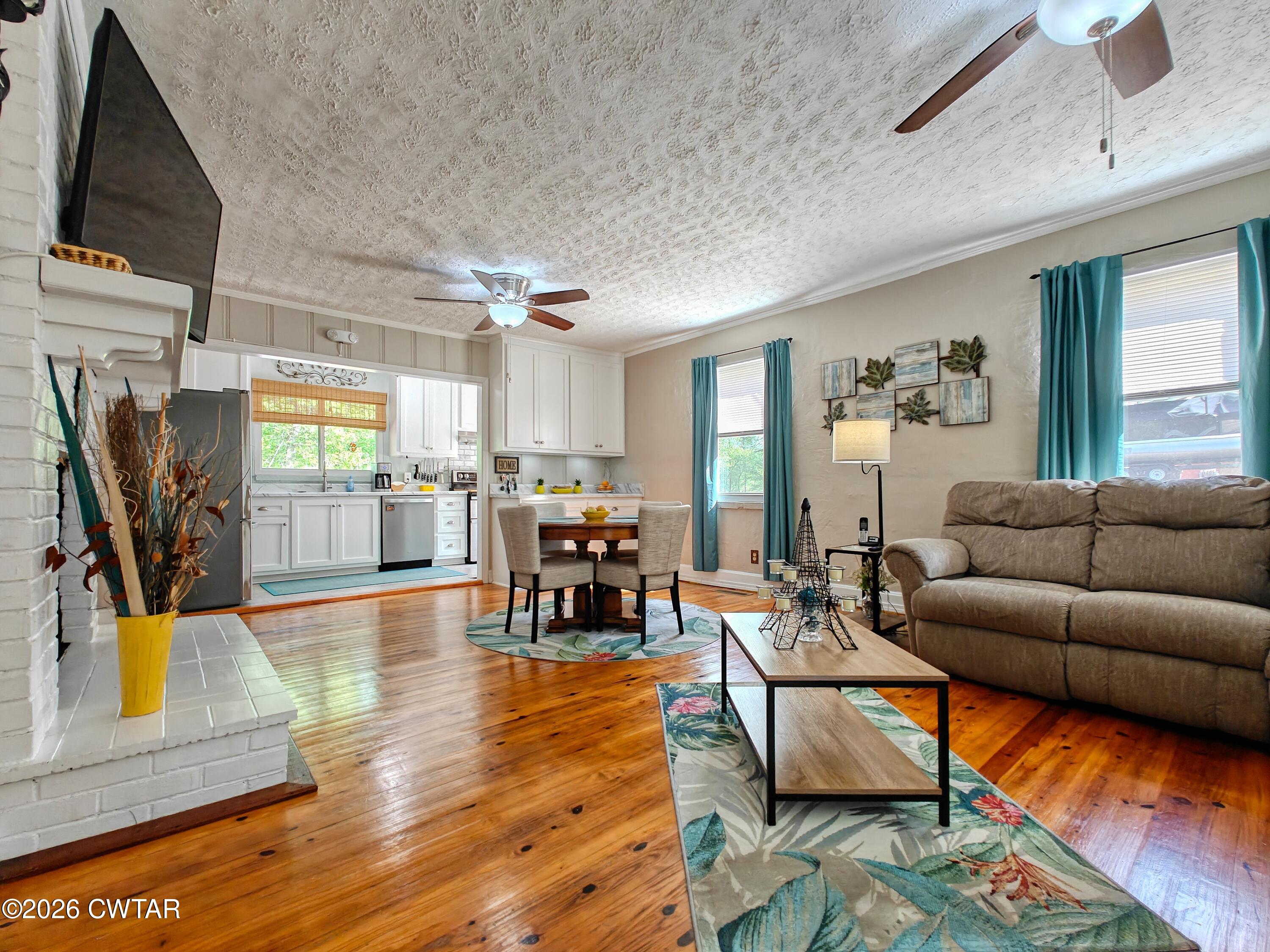 195 Coast Guard Road Buchanan, TN 38222 - Photo 9 of 34 a living room with furniture and a flat screen tv