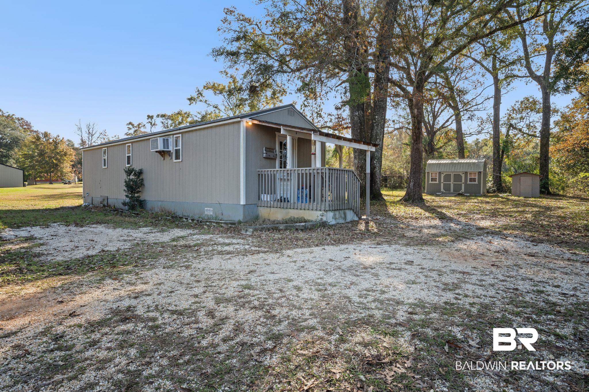 9382 D'Olive Street Bay Minette, AL 36507 - Photo 19 of 27 Exterior space with covered porch and a storage shed