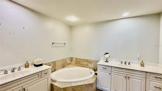 a bathroom with a granite countertop toilet and a sink
