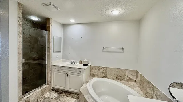 a bathroom with a glass shower door