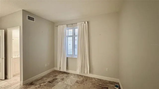 a view of an empty room and window