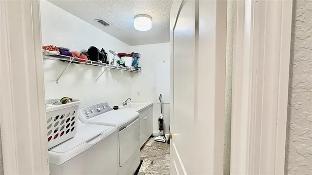 front view of house with a yard and palm trees