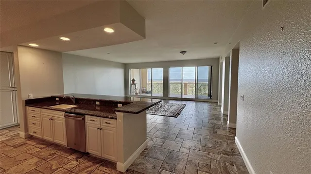 a kitchen with granite countertop a sink and cabinets