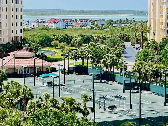 a living room with patio furniture and a large window