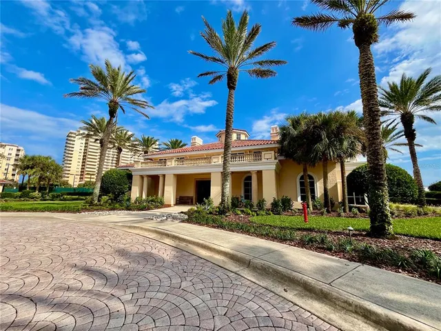 a living room with furniture a large window and stainless steel appliances