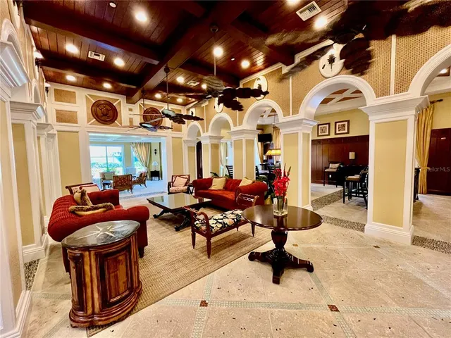 a room with a pool table and windows