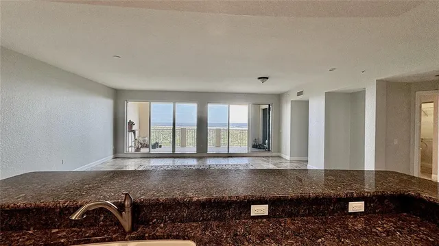 a view of a bedroom with wooden floor and a rug
