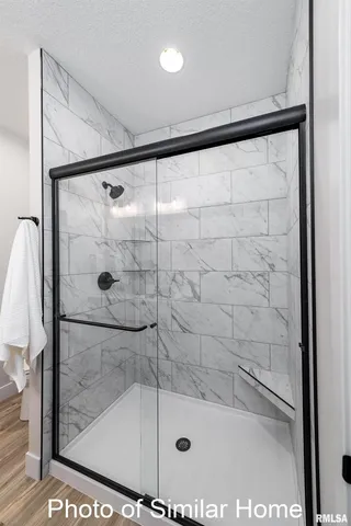 a bathroom with a glass shower door