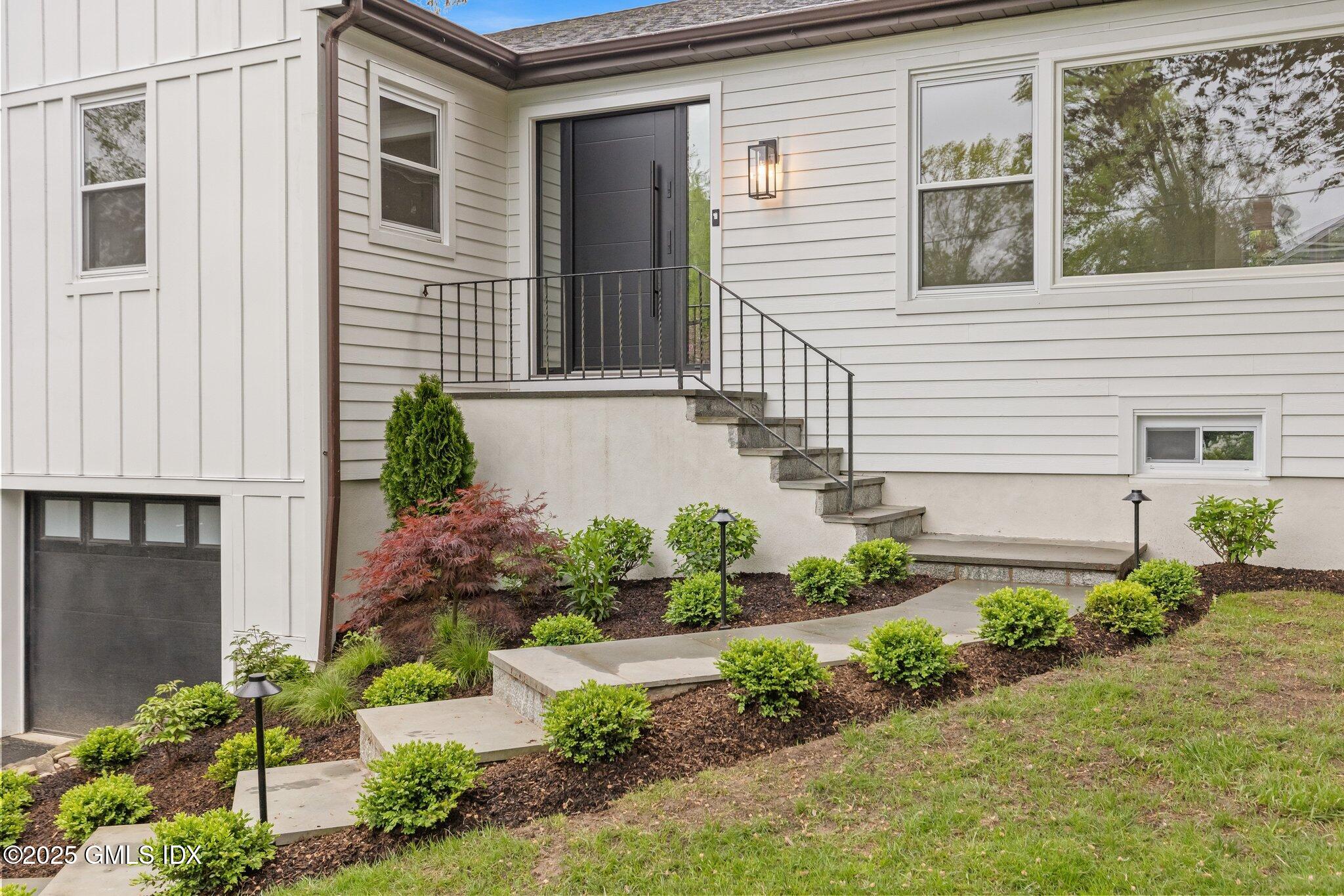 a house that has a lot of flower plants