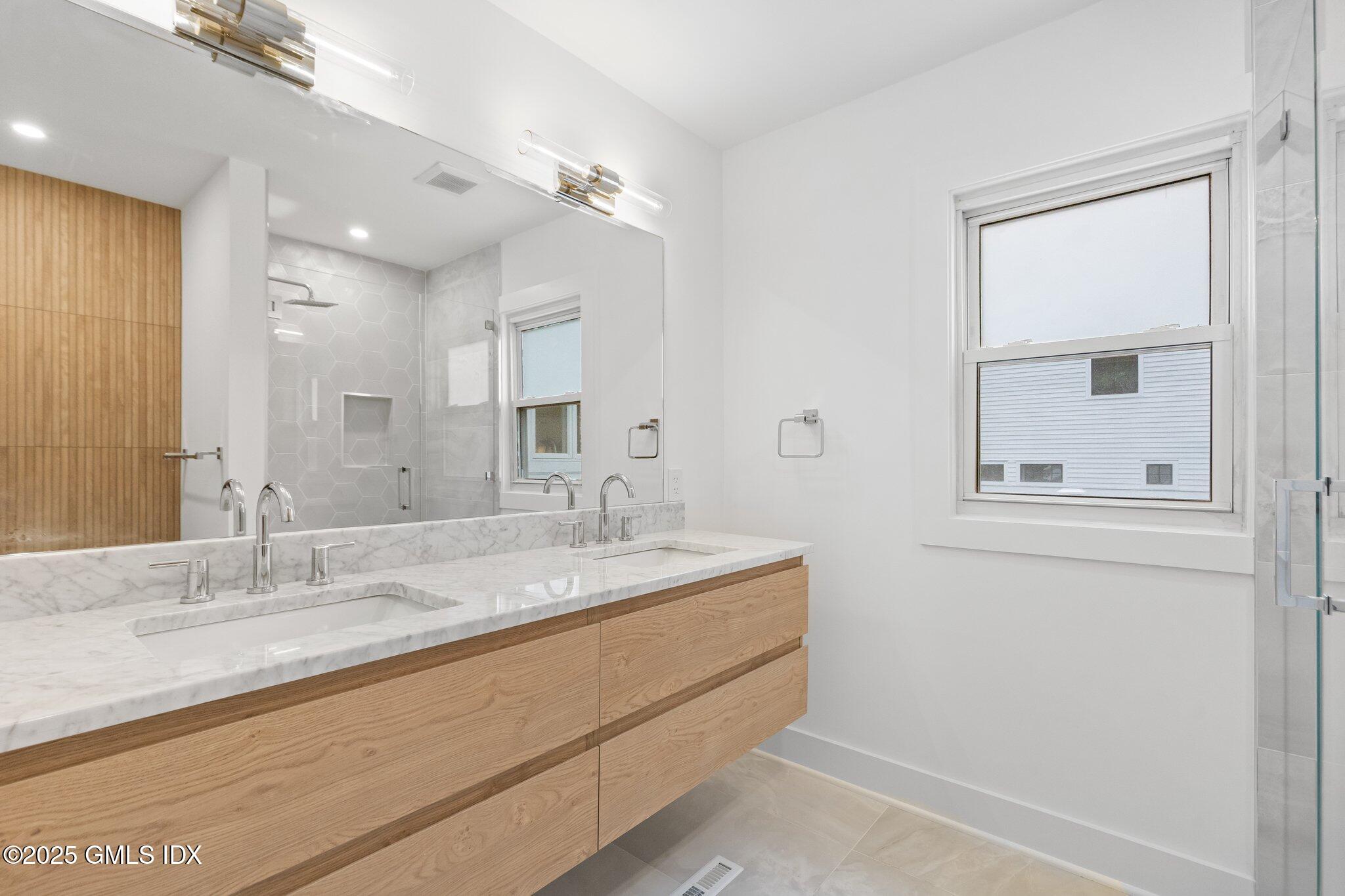 8 Pintail Lane Greenwich, CT 06830 - Photo 19 of 37 a bathroom with a granite countertop sink mirror and vanity