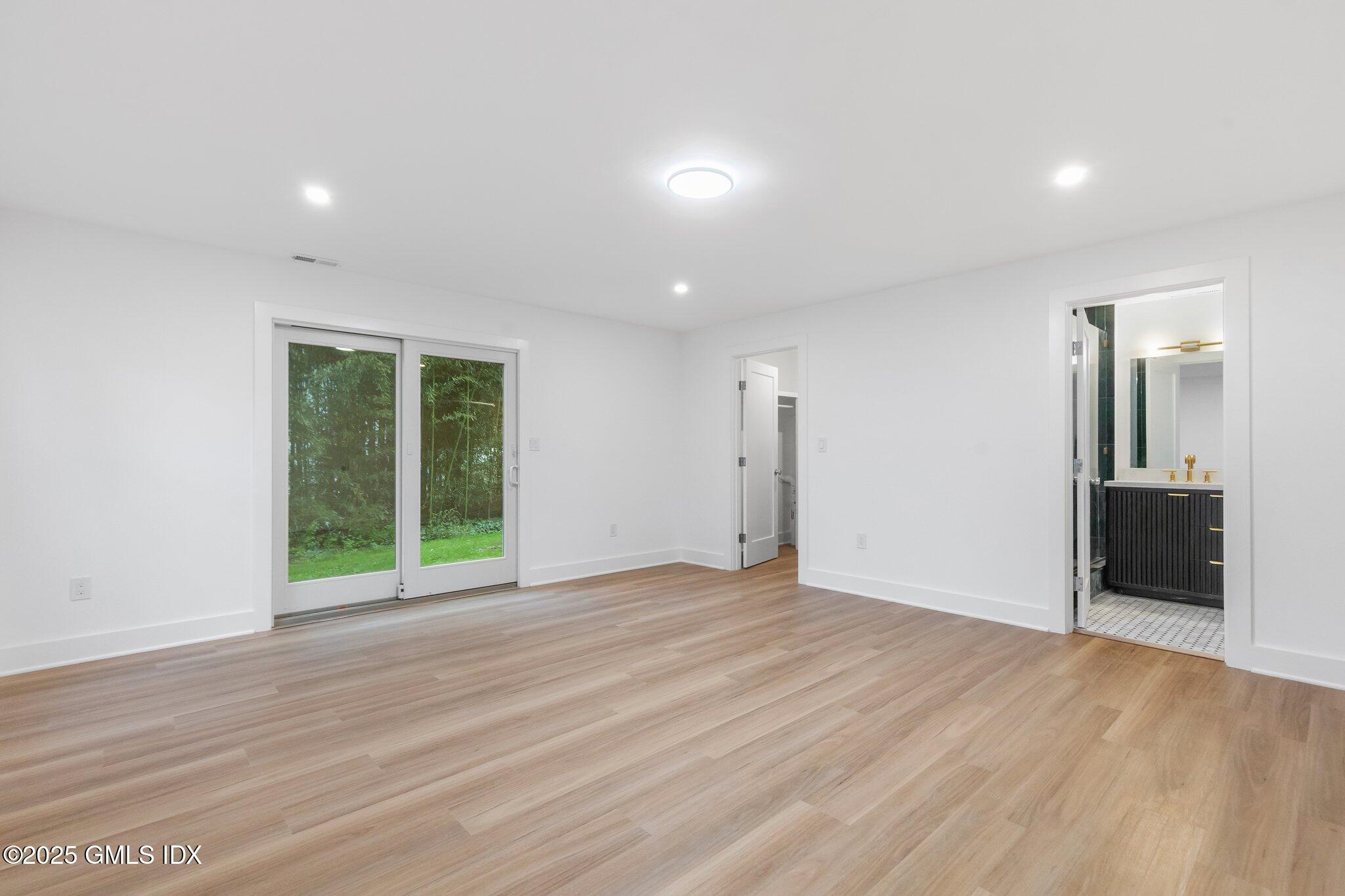 8 Pintail Lane Greenwich, CT 06830 - Photo 27 of 37 a view of an empty room with wooden floor and a window
