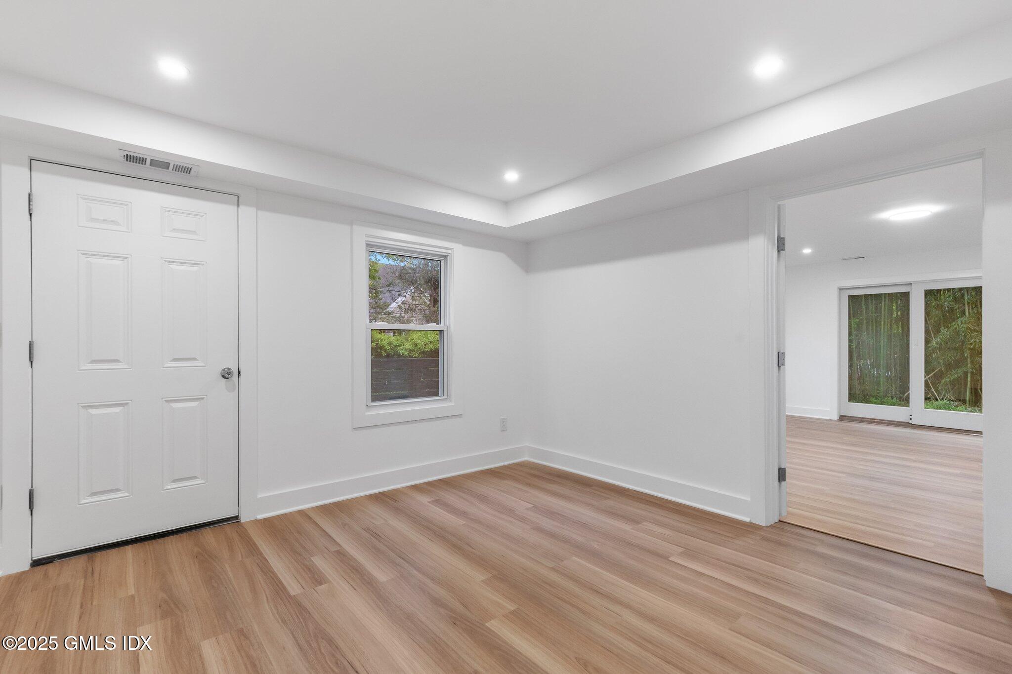 8 Pintail Lane Greenwich, CT 06830 - Photo 31 of 37 a view of an empty room with wooden floor and a window