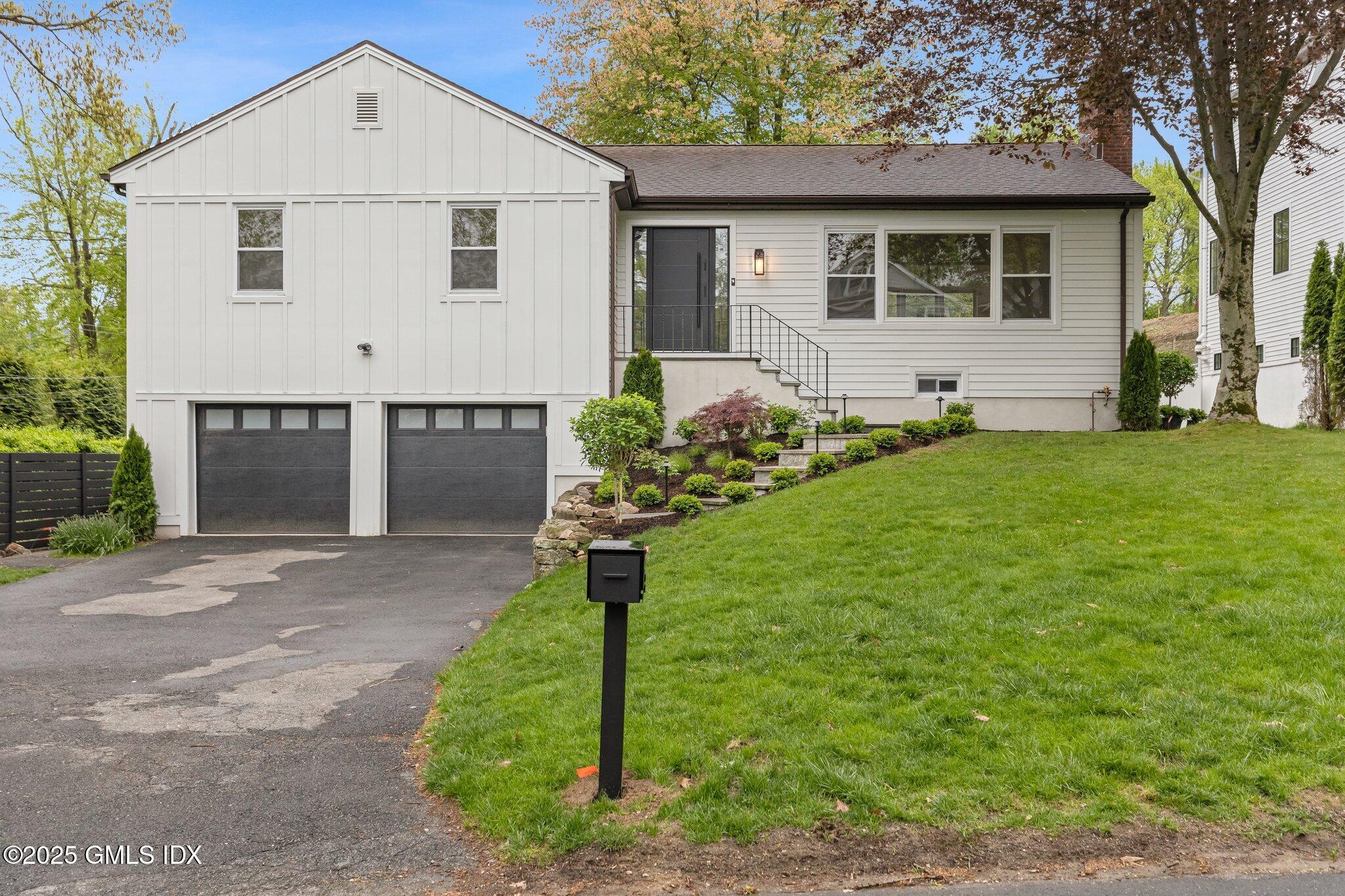 8 Pintail Lane Greenwich, CT 06830 - Photo 35 of 37 a front view of a house with a yard