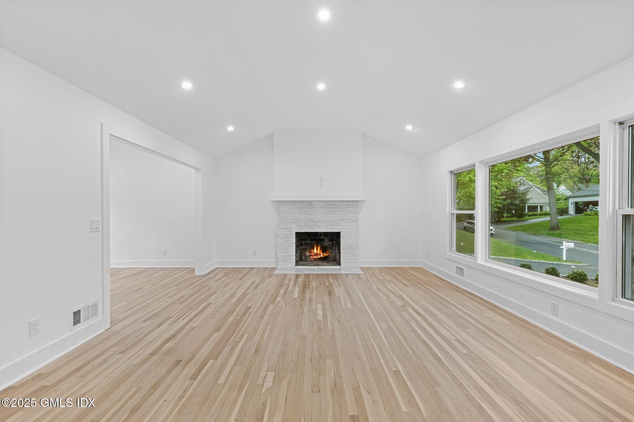 8 Pintail Lane Greenwich, CT 06830 - Photo 5 of 37 a view of an empty room with a fireplace and a window